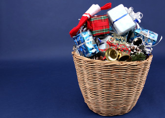 Christmas Day with many gift boxes in the basket and decorations with blue backdrop.