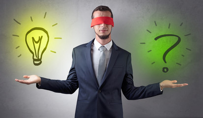 Covered eye businessman with bulb and question sign symbols around