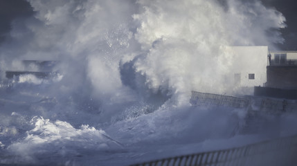 Violent ocean storm surge wave hitting coastal wall in Jersey, UK