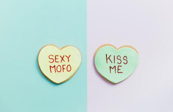 pale valentine candy cookies with messages over pastel background