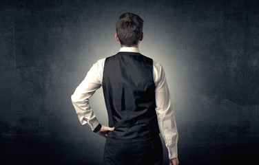 Young businessman standing and thinking alone