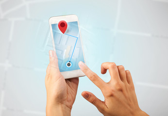 Female fingers touching smartphone with map
