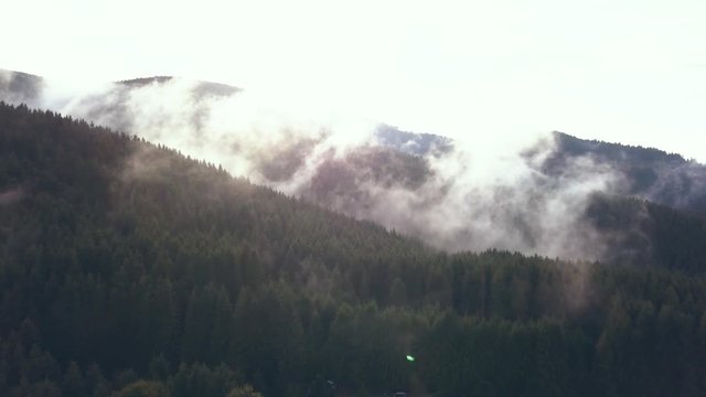 Long Establishing Aerial Drone Shot Punching into Valley Fog on a Beautiful Romanian Mountainside.