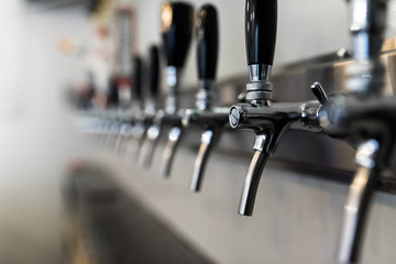 Close-up of beer taps at microbrewery