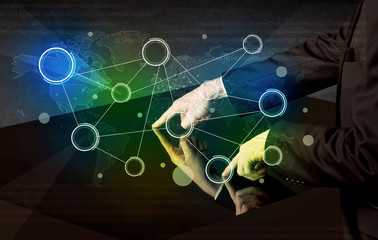 Male hands touching interactive table with colorful world map on it 