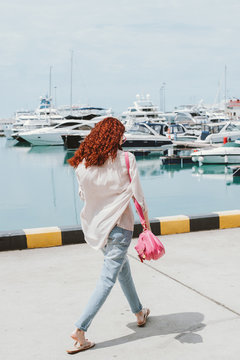 Happy woman walking down the pier