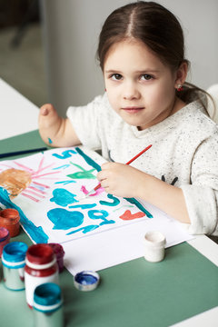 Amputee girl at drawing class