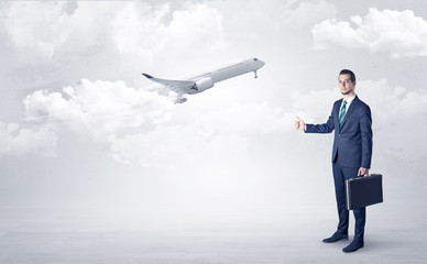Obraz premium Elegant agent hitchhiking with departing airplane concept