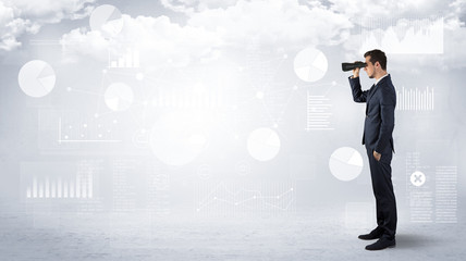 Businessman looking forward with binoculars cloudy background and graphs, charts around
