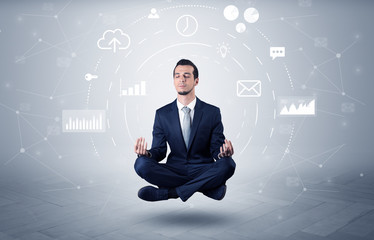 Elegant calm businessman levitates in yoga position with data circulation concept
