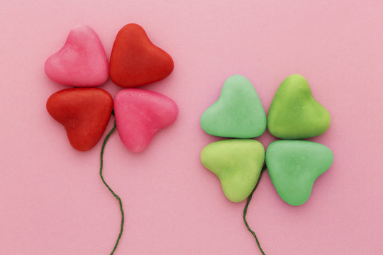 Lucky in love: heart-shaped candy arranged in four-leaf clover shapes