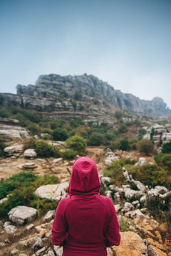 Woman in hoodie looking at El Torcal de Antequera