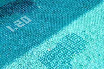 Top view swimming pool with diagonal shadow.
