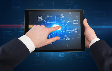 First person view of a hand using tablet with cloud office concept
