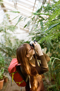 Girl taking photo in the greenhouse