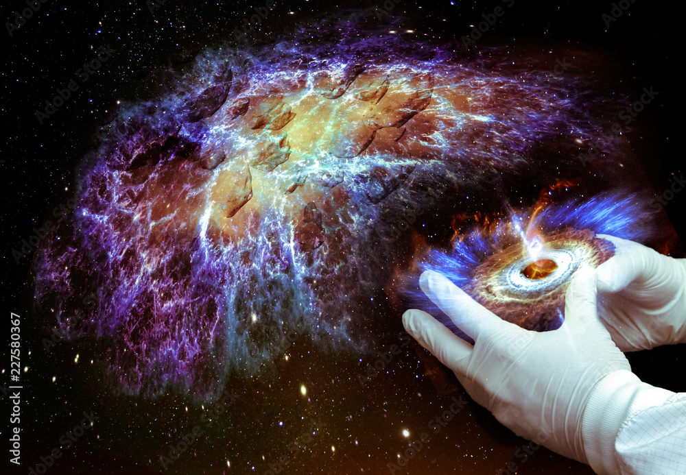 Wall mural the hands of the future scientist in gloves hold a torch and create a new galaxy. elements of this i