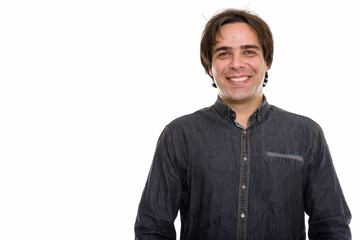 Studio shot of young happy Persian man smiling