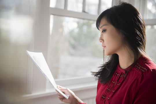 Businesswoman looking at paperwork