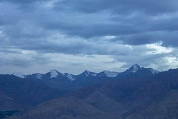 Fototapeta na wymiar cold sky over mountain snowy peaks in the evening