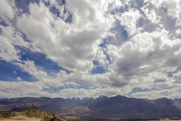 beautiful overcast sky over the mountains with snowy peaks