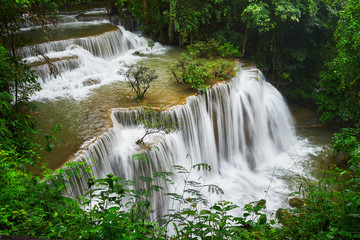 beautiful view of smooth waterfall in forest and rainy day