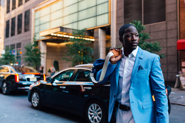 Young businessman walking in the street in New York City