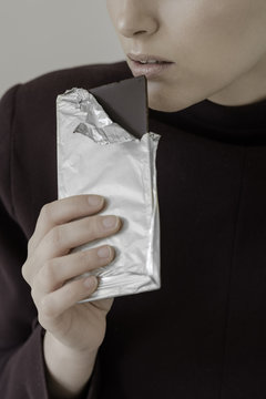Close up of an anonymous female model holding dark chocolate