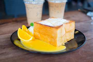 Honey toast served with orange slice