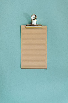 Recycled paper and golden metal clamp
