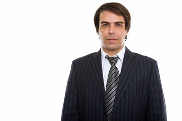 Studio shot of young Persian businessman standing