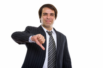 Studio shot of young Persian businessman giving thumb down