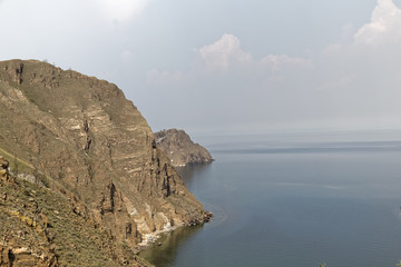 Russia, Lake Baikal - rocks against the backdrop of a misty lake.