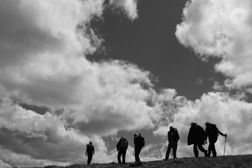 Fototapeta na wymiar Silhouetted walkers on the Isle of Skye