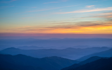 Obraz na płótnie Canvas The picturesque mountain landscape on the sunset background