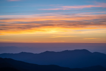 The picturesque mountain landscape on the sunset background