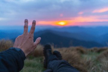 The hand gesturing on the beautiful mountain landscape background