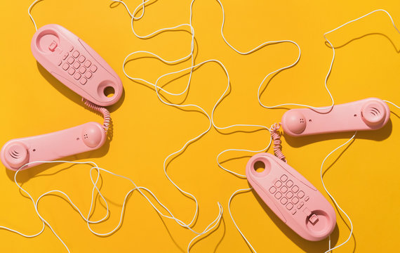 Pink telephones with messy cable