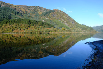 Reflections of autmumn colours in the waters of Loch Lubnaig in the Scottish Highlands
