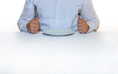 a man is sitting in front of a plate waiting for his food
