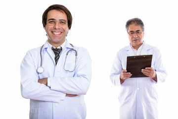Young happy Persian man doctor smiling with arms crossed and sen © Ranta Images
