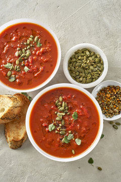 Vegan Tomato Bisque with olive oil, fresh herbs, and pumpkin see