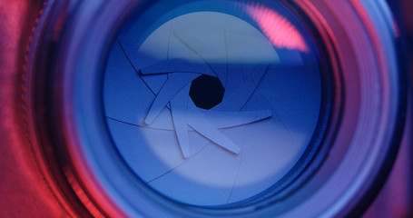 Adjusting Camera lens aperture with pink and purple light