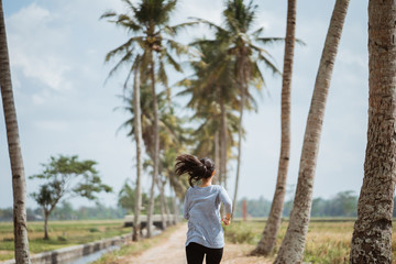 asian woman ran in side rice field