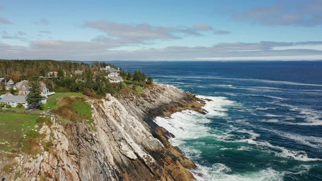 Aerial view of Pemaquid Point Light with backwards dolly movement. The Pemaquid Point Light is a historic US lighthouse located in Bristol, Lincoln County, Maine, at the tip of the Pemaquid Neck.