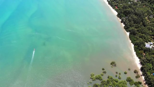 A view from above on a floating boat sailing around the beach of Thailand.