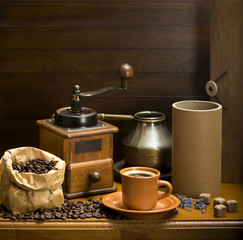 cup of coffee, turka, coffee beans and a coffee grinder, croissants