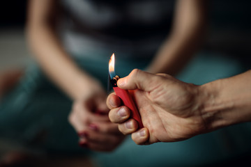 Man lighting a sparkler for a woman