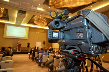 Professional digital video camera. accessories for 4k video cameras. tv camera in a concert hall. Video camera lens - recording show in TV studio - focus on camera aperture