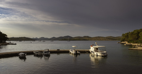 Fototapeta na wymiar Pier with boats in bay of Telascica nature park, Dalmatia, Croatia