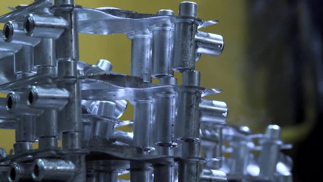 Factory Worker Folds Newly Manufactured Iron Parts